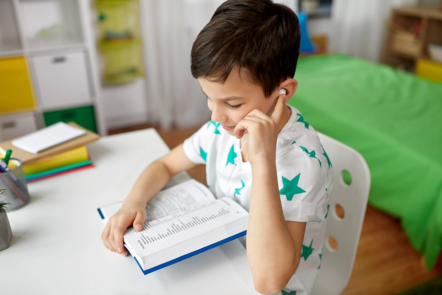 Junior Vocab kid using dictionary to build vocabulary